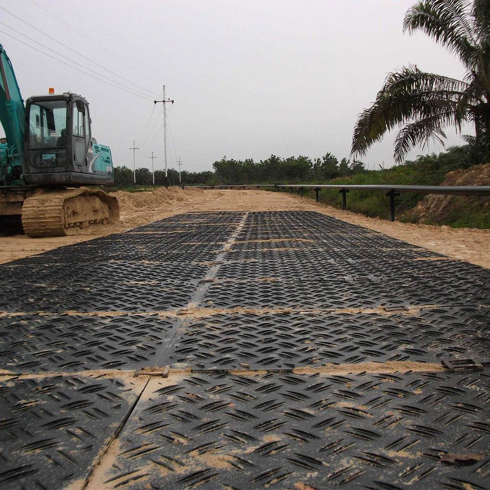 Interlocking ground protection mats forming a temporary access road