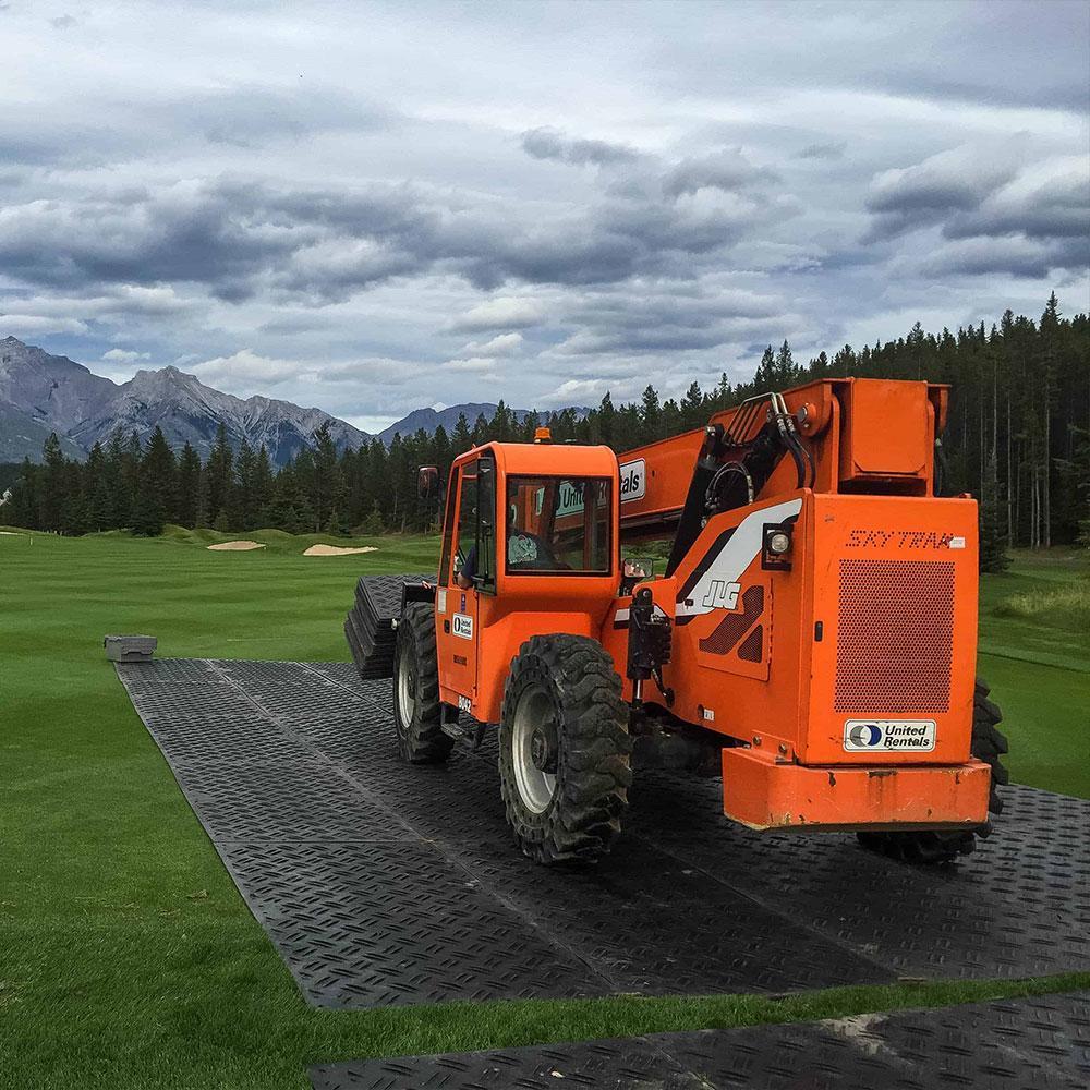 Ground protection mats for heavy equipment creating a stable path over mud