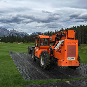 Ground protection mats for heavy equipment creating a stable path over mud